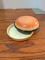 Press open showing lid removed and light green interior