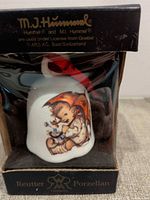 Boxed porcelain bell with Hummel artwork front view