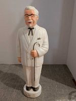 Front view of Colonel Sanders ceramic piggy bank showing overall form and condition