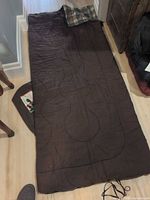 Sleeping bag fully laid out showing full length and plaid head section