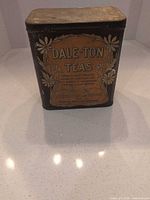 Front view of Dale-Ton Teas metal tin showing label and surface wear