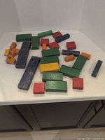 Pile of assorted coloured wooden blocks on countertop