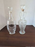 Front view of both glass decanters with stoppers