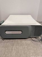 Front view of Xbox 360 console showing 250GB hard drive bay