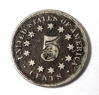 Reverse view showing numeral 5 and stars