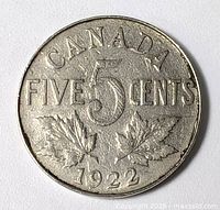 Reverse of 1922 Canadian five-cent coin showing denomination and maple leaves