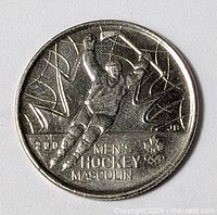 Reverse of coin showing hockey player design and inscriptions