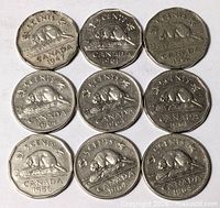 Front view of nine Canadian nickels arranged 3×3 showing reverse beaver design and dates.