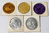 Group shot of five Mardi Gras doubloon coins in cardboard flips