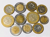 Group view of eleven mixed world coins showing obverse designs and denominations