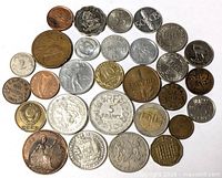 Overall shot of the 32 mixed world coins spread on white background