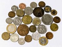 Full group of mixed world coins spread out for count and overview