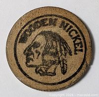 Front view of wooden nickel showing clear imprint