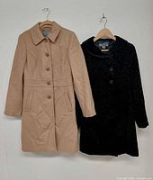 Front view of both coats on hangers, showing colors and style