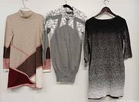 All three sweater dresses hanging front view