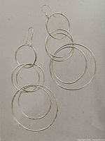 Front view of both earrings showing hoop arrangement and hooks