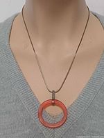 Necklace on mannequin showing pendant and chain drape