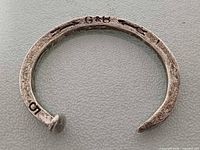 Cuff bracelet front view showing G&B stamp and nail-head end