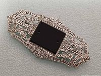Front view of sterling marcasite and onyx brooch