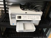 HP Photosmart Premium printer front showing LCD screen, buttons, paper tray, and memory card slots