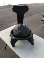 Front view of the Fit Chair showing the tall backrest and partially deflated balance ball in the seat.