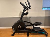 Full left-side view of Nautilus E618 elliptical showing frame, pedals, arms and base