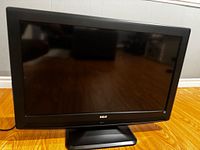 Front view of RCA 32" LCD TV on stand powered off