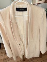 Front view on hanger showing texture, lining, Zara Basic label
