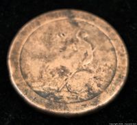 Obverse view of worn copper penny, Britannia outline faintly visible