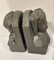 Front angled view of both bookends showing male and female busts and bronze finish