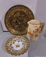 Full view of brass plaque, pitcher and dish
