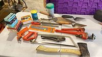 Overall view of hand tools and fasteners on table