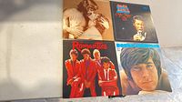 Four LP jackets laid out showing front artwork