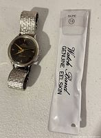 Watch with metal bracelet and packaged eel-skin strap