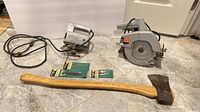 Overall lot showing circular saw, jigsaw, axe, three blade packs