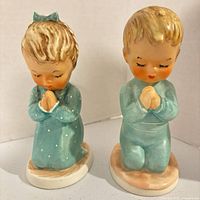 Front view of both Goebel Hummel praying child figurines