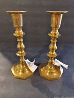 Full view of both brass candlesticks front