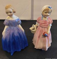 Front view of both figurines showing overall design and colours
