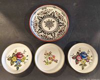 Top view showing complete set: Minton bowl above three Royal Worcester saucers
