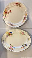 Round dinner plate above oval platter, showing floral pattern and gold trim