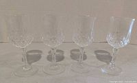 Four cut crystal wine glasses front view