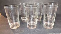 All six clear etched starburst highball glasses front view