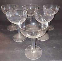 Front angled group shot of six clear coupe glasses