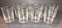 Front view of eight etched starburst shot glasses