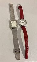 Front view showing both watches, cases and bands