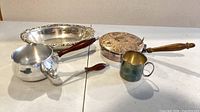 All six items grouped: saucepan, ladle, pancake pan, cup, oval bowl