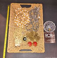 All items on woven tray with measuring tape for scale