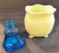 Yellow vase and blue inkwell side by side