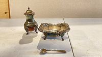 Full view of pepper caster, salt cellar and spoon