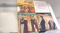 Front covers of four LPs on tabletop